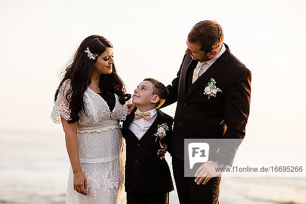 Newlyweds & Nine Year Old Son Standing on Rock at Beach in San Diego