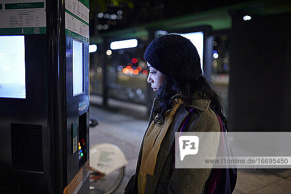 woman Using ATM at night