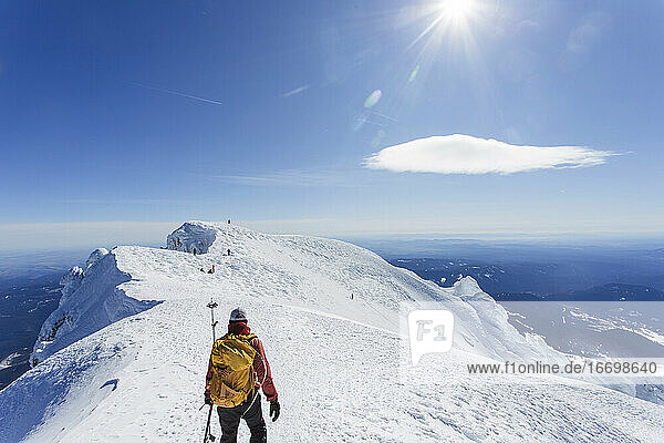 A man climbs to the summit of Mt. Hood in Oregon.