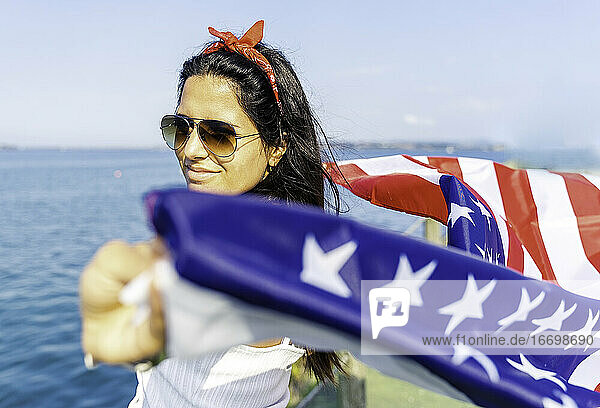 Junge Frau hält amerikanische Flagge