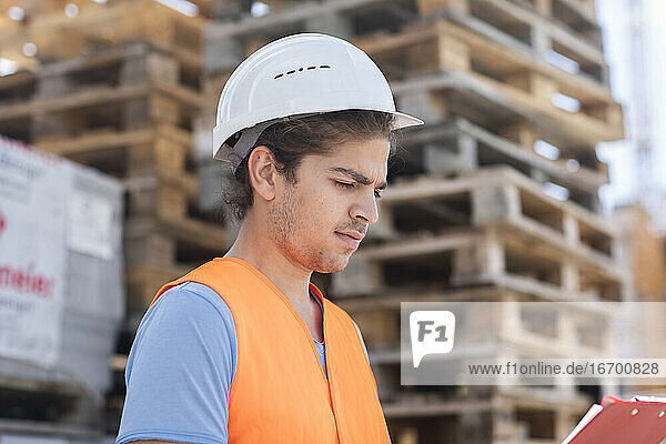 young store worker with helmet working outside