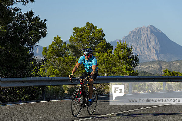 Man riding a bicycle on a Costa Blanca mountain road
