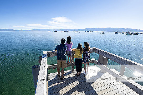 A family relaxes on a pier on a beautiful day in South Lake Tahoe  CA