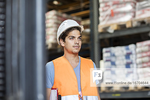 young store worker with helmet working in a store