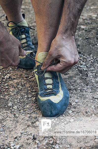Tying the laces of climbing shoes.