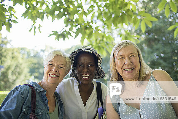 Portrait happy beautiful senior women friends in summer park