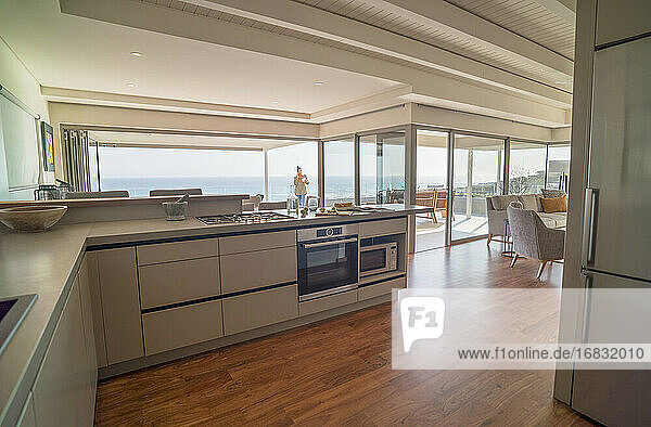 Modern home showcase interior kitchen with sunny ocean view