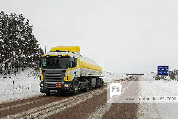 Lastwagenfahrt auf verschneiter Landstraße.