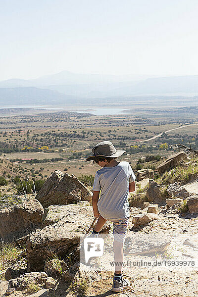 Young boy hiking on Chimney Rock trail  through a protected canyon landscape