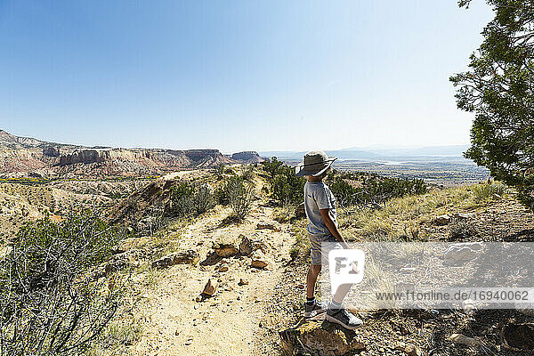 young boy hiking on Chimney Rock trail  through a protected canyon landscape