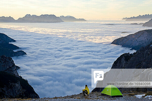 Man and tent above the clouds  Trentino-Alto Adige  South Tyrol in Bolzano district  Alta Pusteria  Hochpustertal Sexten Dolomites  Italy