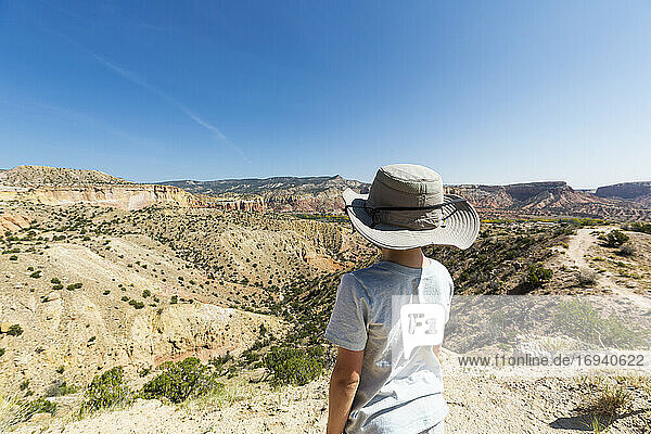 kleiner Junge beim Wandern auf dem Chimney Rock Trail  durch eine geschützte Canyonlandschaft