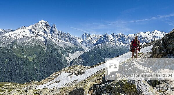 Hiker on hiking trail  Grand Balcon Sud  glacier  Mer de Glace  Aiguille Verte and Mont Blanc summits  Grandes Jorasses  Mont Blanc massif  Chamonix-Mont-Blanc  Haute-Savoie  France  Europe