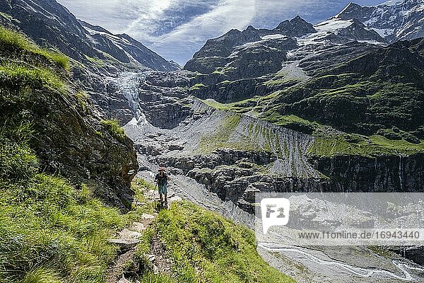 Hikers in the mountains on a hiking trail to Grindelwald  glacier Lower Arctic Ocean  Bernese Oberland  Switzerland  Europe