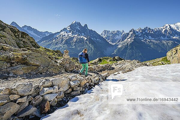 Hiker on trail  Grand Balcon Sud  Aiguille Verte and Aiguille du Midi peaks  Grandes Jorasses  Mont Blanc massif  Chamonix-Mont-Blanc  Haute-Savoie  France  Europe