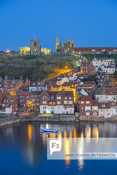 View of St. Mary's Church and Whitby Abbey from across River Esk at dusk  Whitby  Yorkshire  England  United Kingdom  Europe
