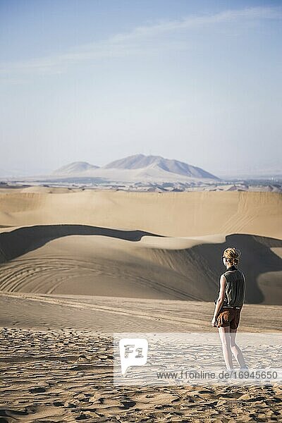 Tourist exploring sand dunes in the desert at Huacachina  Ica Region  Peru