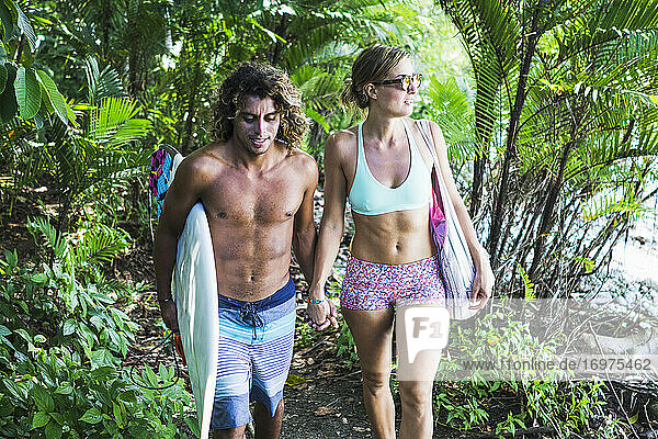 Multi ethnic couple of there way to the beach in Costa rica