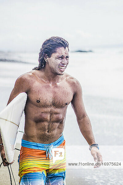 Surfer in Costa Rica standing on beach
