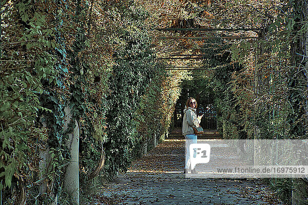 Woman walking in park at autumn time