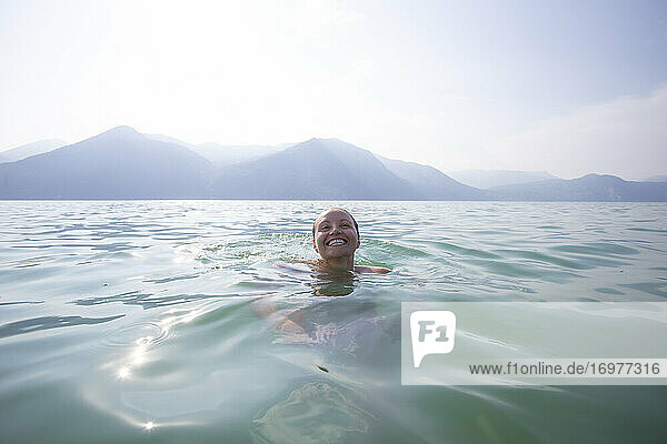 A floating  smiling head in the middle of lake Iseo in Italy