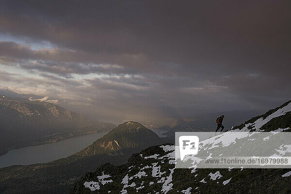 A young man climbs on Dog Mountain overlooking the Columbia Gorge.