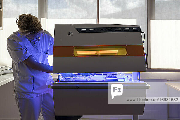 Neugeborenes in einem Inkubator. Eine Krankenschwester kümmert sich um das Baby