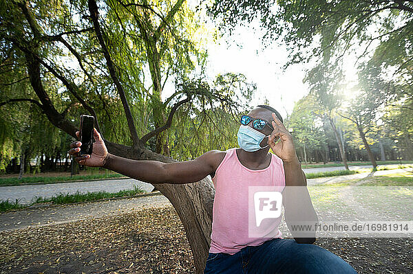 A young black man with a mask in the covid-19 pandemic season.