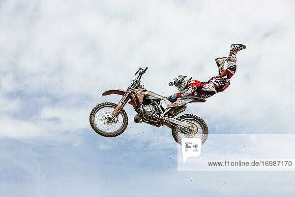 Motocross rider jumping in front of cloudy sky  Biberach  Baden-Württemberg  Germany  Europe
