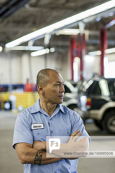 Portrait of Pacific Islander car mechanic in auto repair shop