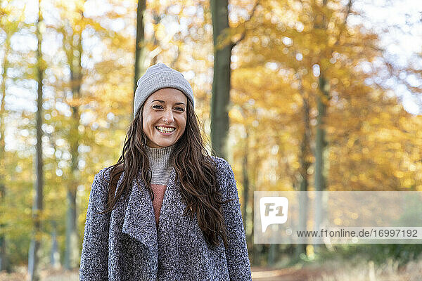 Beautiful female hiker standing in Cannock Chase forest during autumn