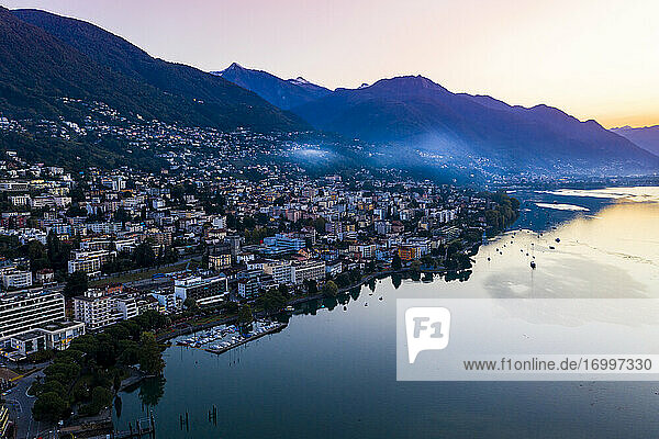 Switzerland  Canton of Ticino  Locarno  Helicopter view of town on shore of Lake Maggiore at dawn