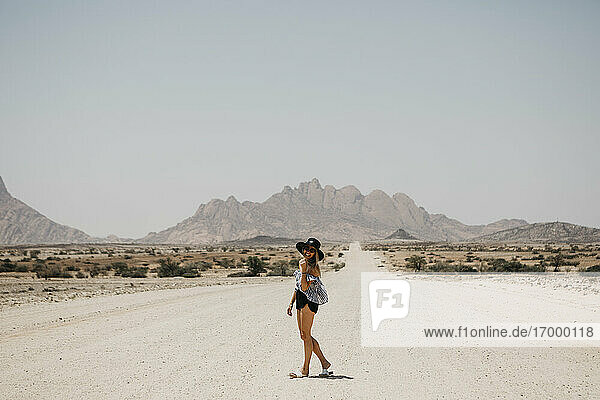 Namibia  happy woman on the road to Spitzkoppe