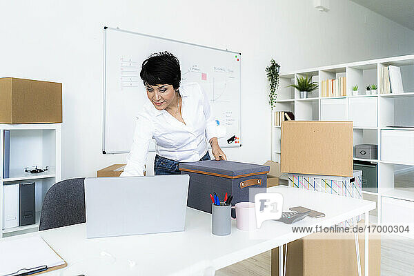 Businesswoman organizing office before relocation