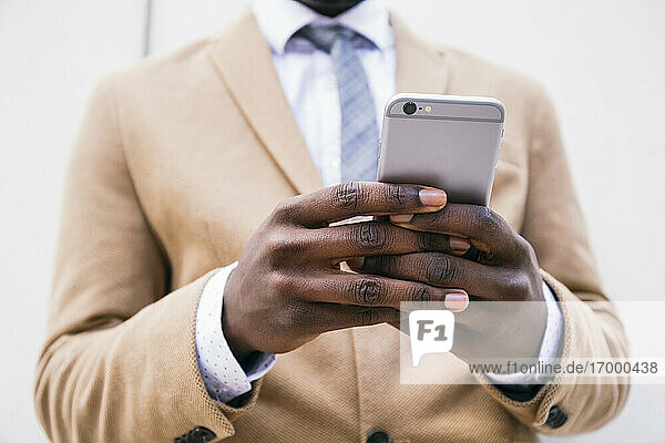 Hands of a businessman using smartphone
