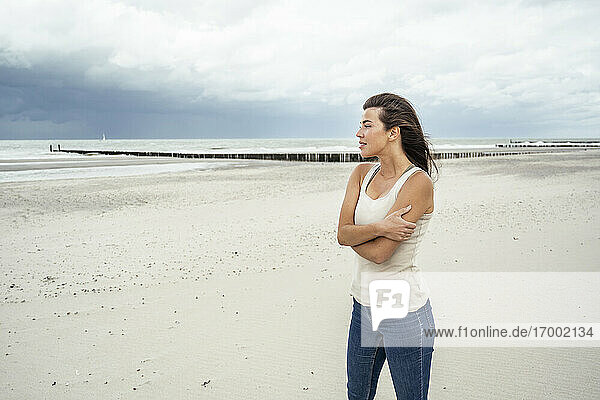 Young woman looking at view while standing at beach