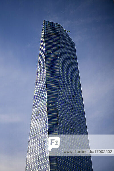 Spanien  Madrid  Plattform für Fensterputzer hängt an einem hohen modernen Wolkenkratzer