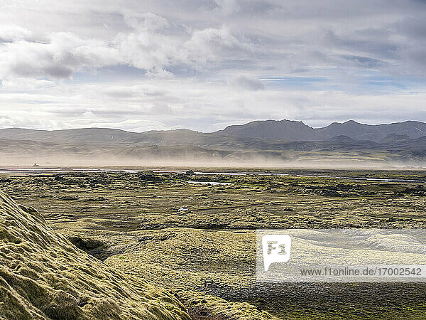 Landscape scenery with sandstorm against cloudy sky  Lakagigar  Iceland