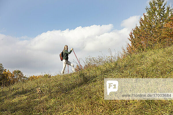 Mature woman with backpack hiking on mountain at Alpine Foothills  Germany
