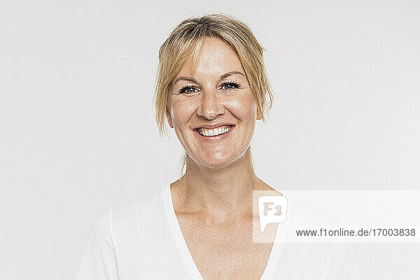 Happy mature woman against white background