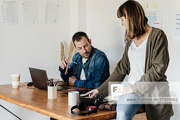 Business couple discussing about strategy while working at home