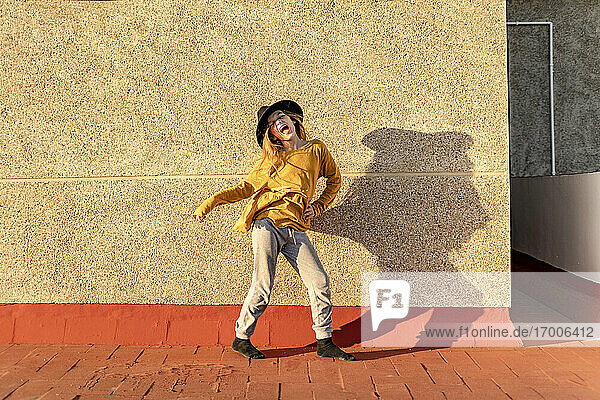 Portrait of girl singing and dancing on roof terrace