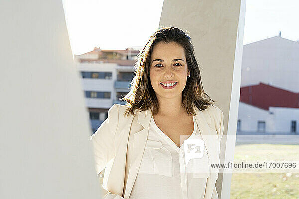 Smiling female entrepreneur in city on sunny day