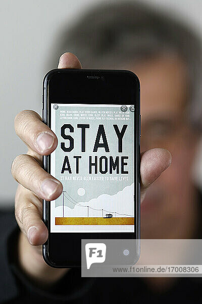 Coronavirus epidemic (COVID-19). Close-up on a smartphone: stay at home. France.