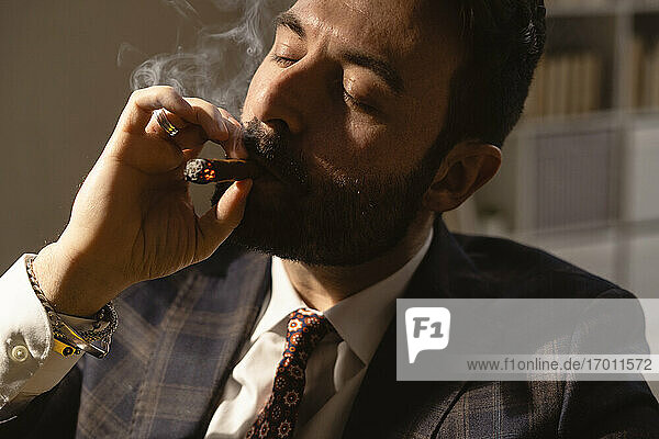 Portrait of bearded man smoking cigar