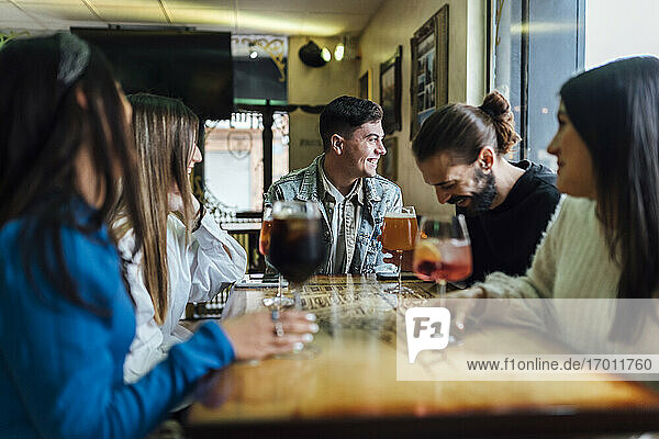 Friends spending leisure time with beer in restaurant