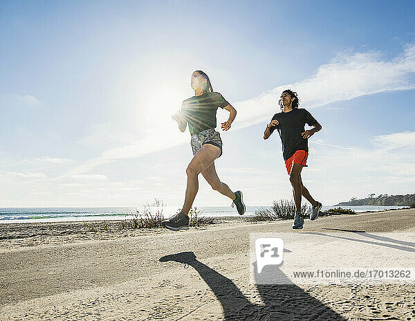 USA  California  Dana Point  Man and woman running together by coastline