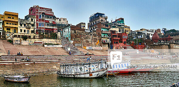 Varanasi (ex-Bénares)  Uttar Pradesh  India. The Ganges River at Varanasi which is the holiest city in India where pilgrims  Hindu People and tourists come to visit  bathe  meditate  worship and cremate their dead in the Holy River. It's also the place where the ghats are located with terraces  palaces  steps and palvillions since the 7th Century.