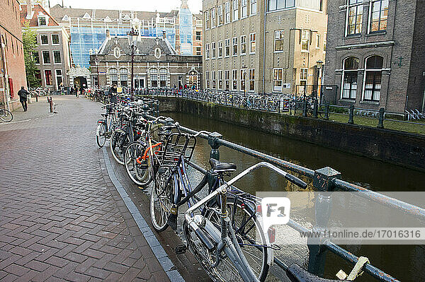 Europe  Netherlands  Amsterdam  canal and bicycles on tehe bridge