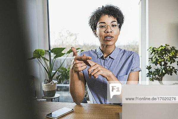 Woman sitting in front of computer  having video conference